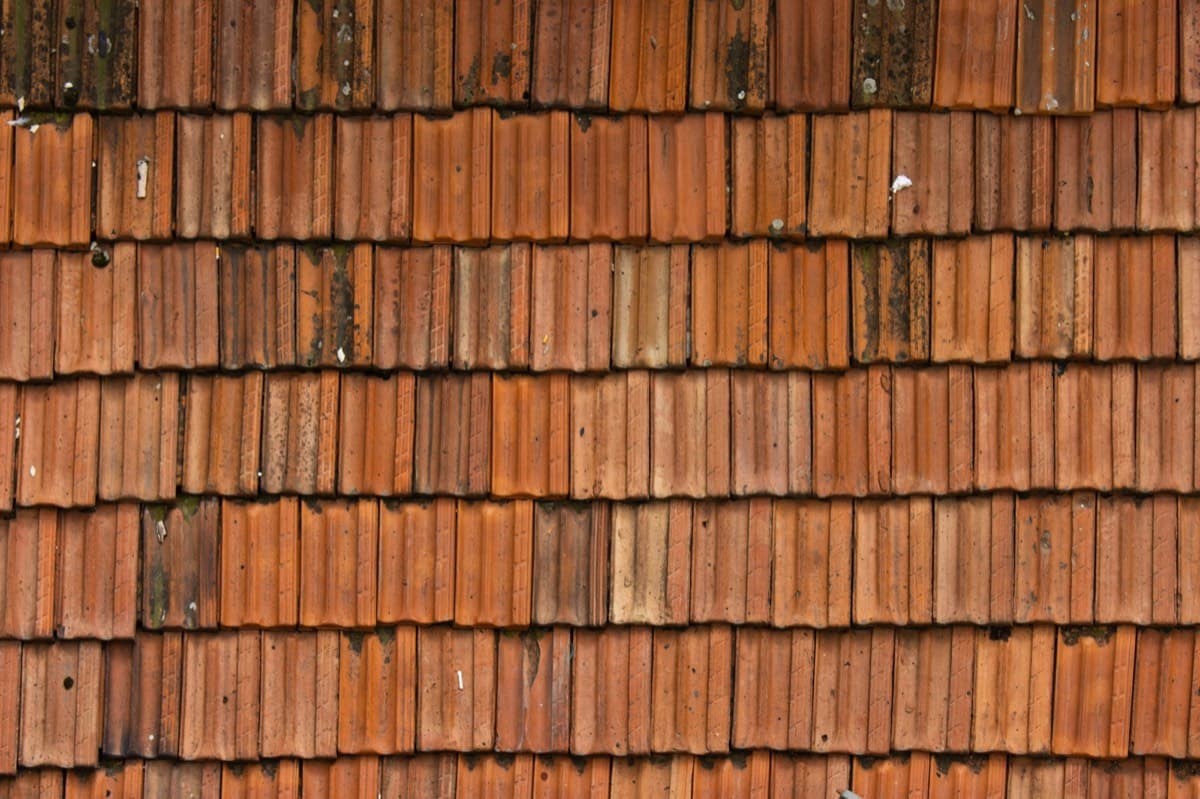 Damaged bitumen roof covering with a leak
