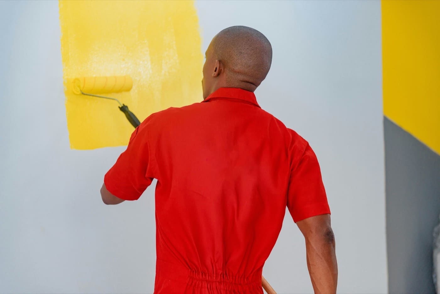 Tradesman carrying out a small job: painting and fitting work in a home